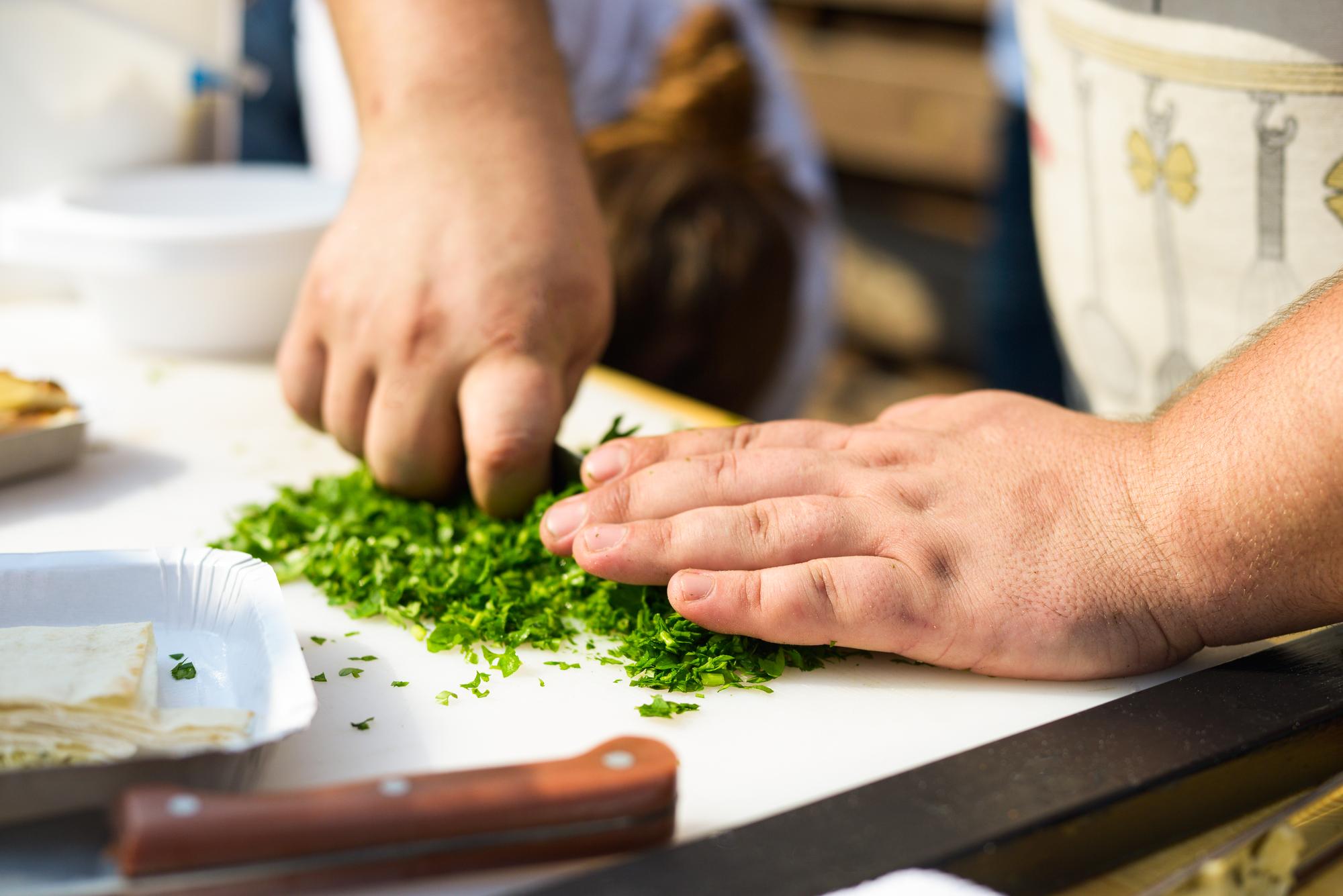 Workshop station with participants chopping herbs